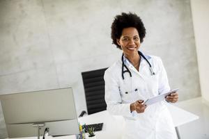 Doctor holding documents and smiling photo