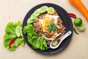 Fried rice with shrimp in black dish on the table photo