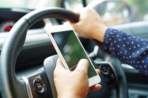 Holding mobile phone in car to communication photo