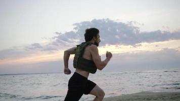 Young bearded athlete training outdoor with weighted vest video