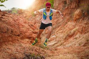 A man Runner of Trail . and athlete's feet wearing sports shoes for trail running in the mountains photo