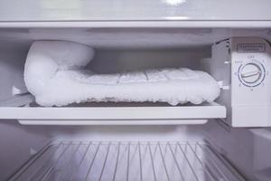 frozen Ice buildup in the freezer of refrigerator photo
