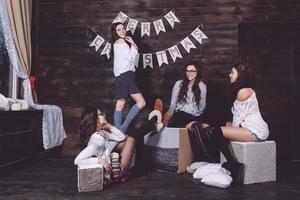Four charming model posing on a vintage New Year's background photo