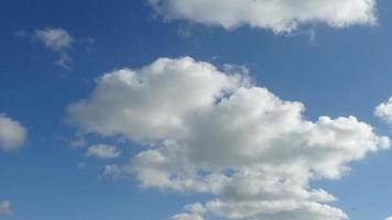 Stunning time lapse of sunlight and moving clouds in the blue sky. video