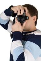 Young man with a digital camera. Isolated on white photo