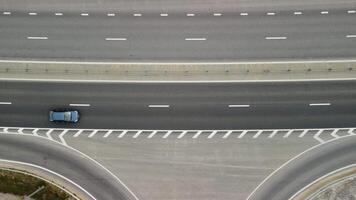 Top down aerial view of new highway high speed road intersections with few vehicles moving in the morning. video