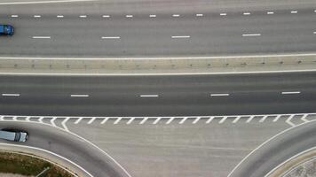 Top down aerial view of new highway high speed road intersections with few vehicles moving in the morning. video