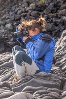 female nature photographer in action photo