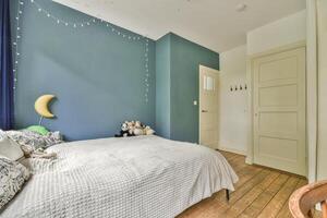 A bedroom with blue walls and wooden floors photo