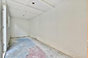An empty room with a door and a window photo
