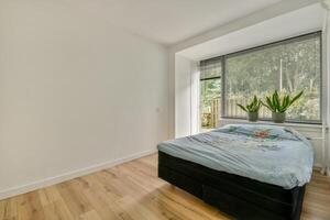 A bedroom with a bed and a window photo
