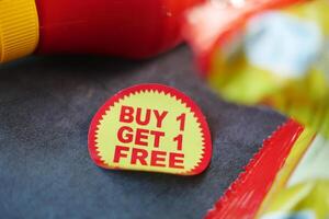buy 1 get 1 free offer sticker and prodcuts on table photo