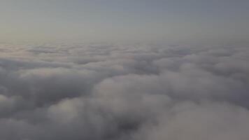 View from a drone on a sea of clouds to the horizon at dawn video