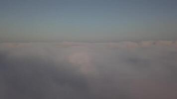 View from a drone on a sea of clouds to the horizon at dawn video