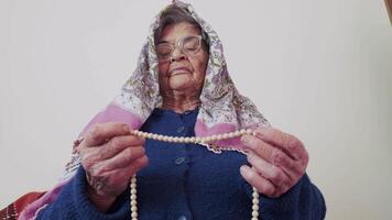 Old Muslim Woman is Counting Prayer Beads video