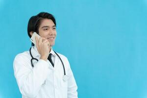 telemedical. Doctors use mobile phone for discuss and advising patients Asian doctor is treating patients through telecommunication while describing the disease . Technology for health. photo