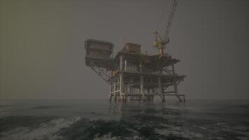 An offshore oil rig standing tall in the vast expanse of the open ocean video