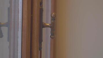 woman hand trying to open a vintage door in an elegant interior space video