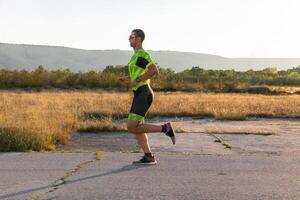 Triathlete in professional gear running early in the morning, preparing for a marathon, dedication to sport and readiness to take on the challenges of a marathon. photo
