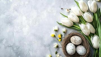 A delicate arrangement of white tulips beside a nest filled with colorful quail eggs, symbolizing spring, nature, and Easter celebrations. photo