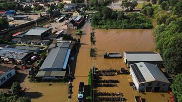 aérien vue de inondé chemin de fer des pistes et bâtiments dans de banlieue zone. industriel zone avec les eaux de crue après lourd pluie. concept de Naturel catastrophe, climat impact et urgence video