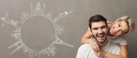Happy couple at grey backround with drawn circle from world sights simbols, copy space. Happy travelers concept photo